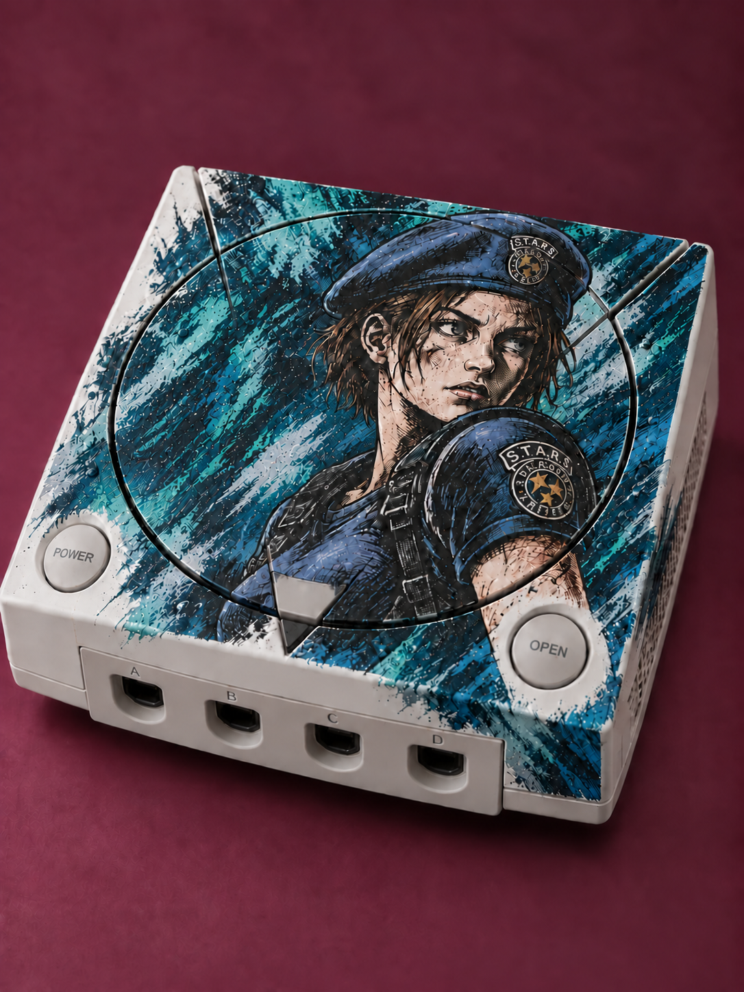 Character illustration in dark ink over an icy teal and silver-blue painted console shell against a burgundy studio backdrop